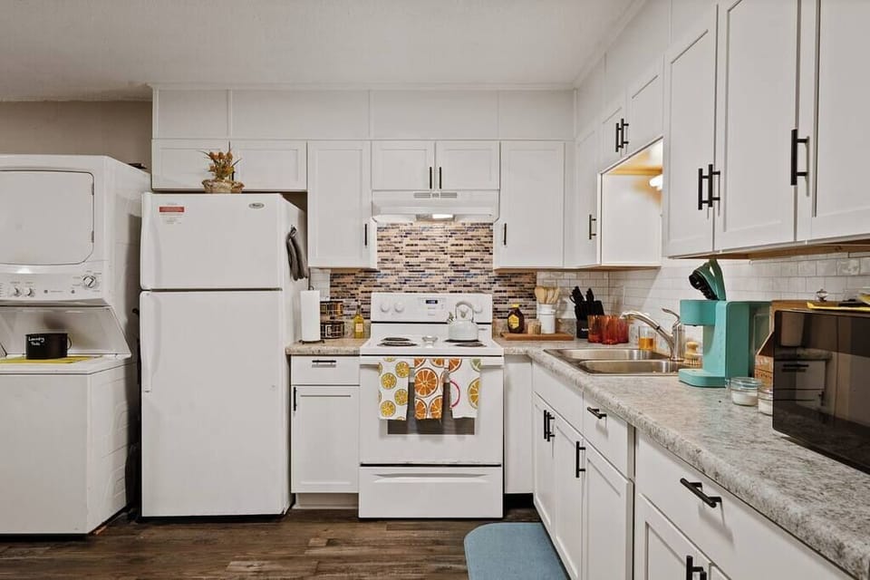 Functional kitchen w/ ample counter space, white cabinetry & everything within easy reach