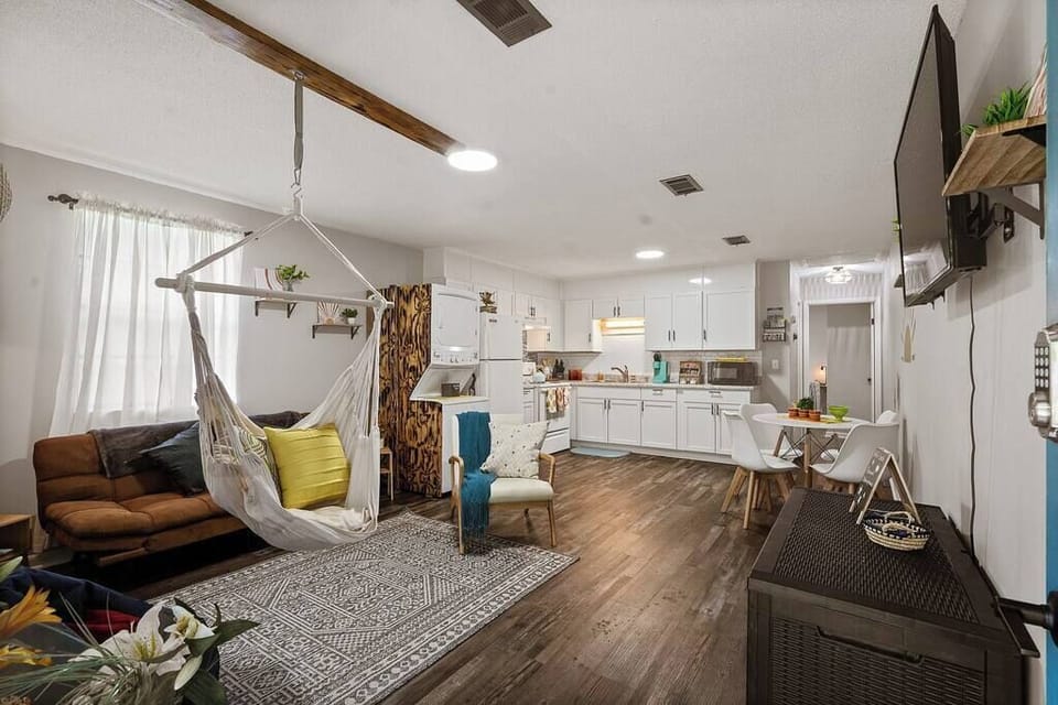 Stylish living room w/ modern decor, warm wood floors & open flow
