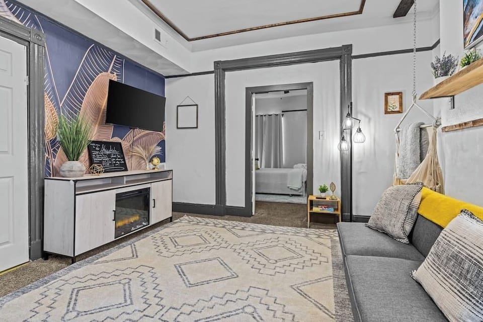 A bright and modern living area with cozy seating, a stylish rug, and natural light. Perfect for relaxing after a day of exploring.