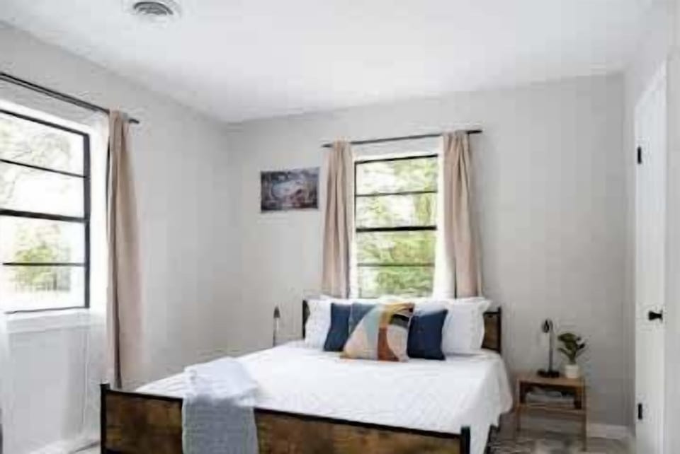 A cozy bedroom with a queen bed, soft linens, and decorative touches for a restful retreat.