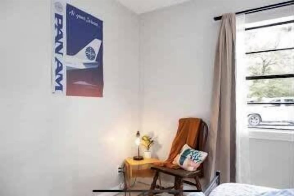 A small, inviting reading or work nook with a chair, soft lighting, and rustic accents.