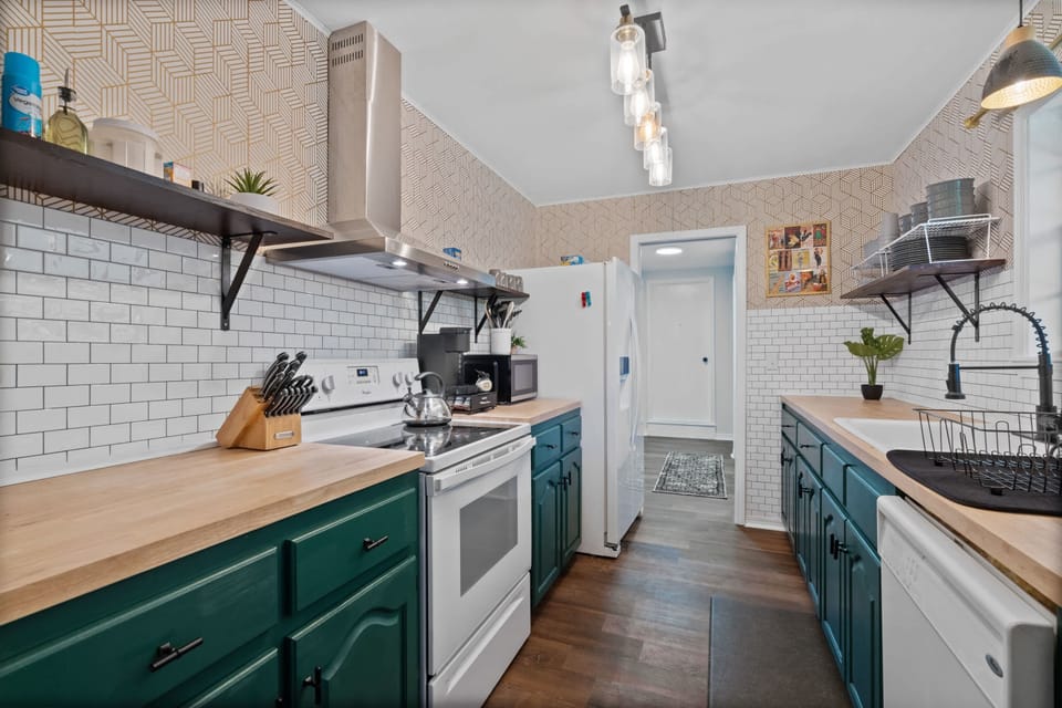 Bright kitchen w/ teal cabinets, open shelving & plenty of counter space
