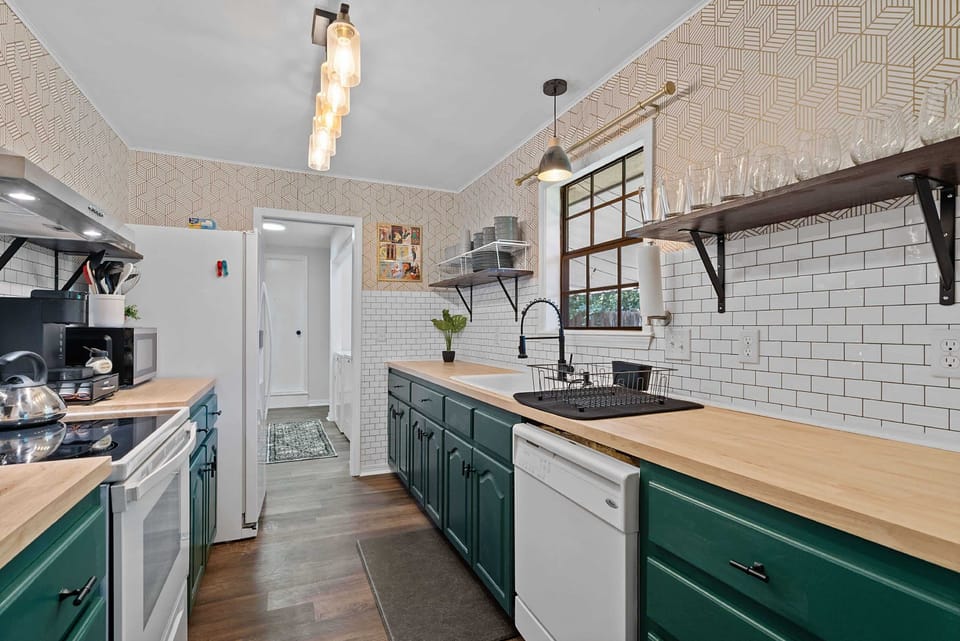 Another angle of the kitchen highlighting long counters & modern finishes