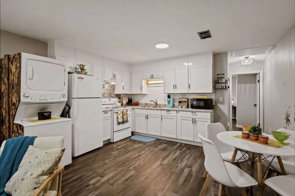 Sleek kitchen w/ full appliances & bar seating for easy cooking & dining
