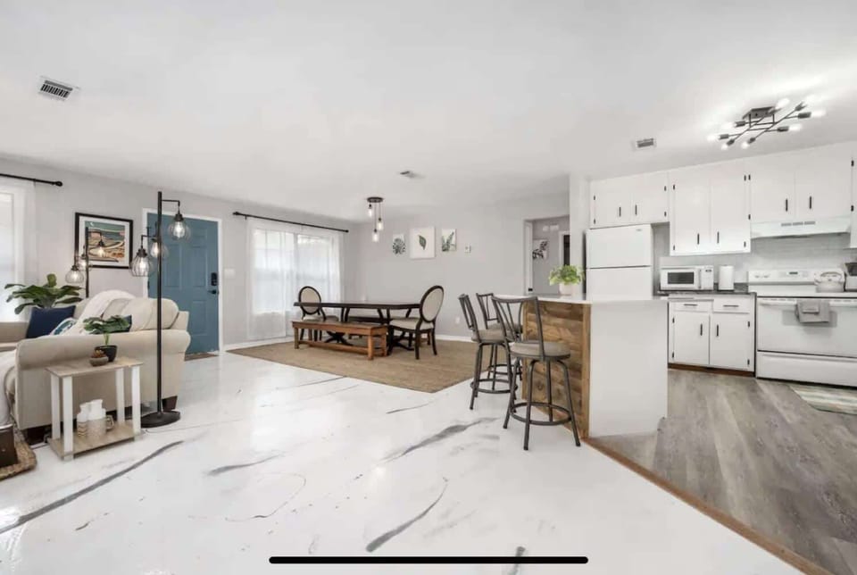 Open living & kitchen space w/ airy layout, bar seating & plenty of room to gather