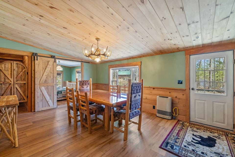 This warm dining area offers plenty of seating, wood finishes, and a welcoming atmosphere.