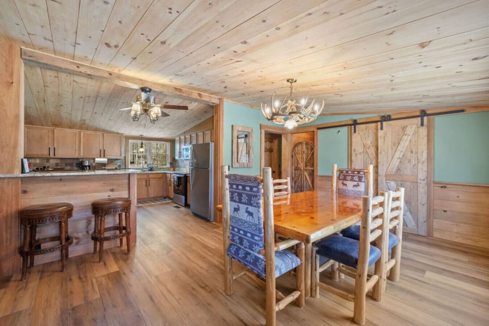 Warm wood finishes and a large table make this kitchen and dining area.