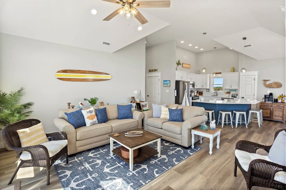 The spacious Living Area boasts high ceilings, a Smart TV, sound bar, and plenty of cozy furniture.