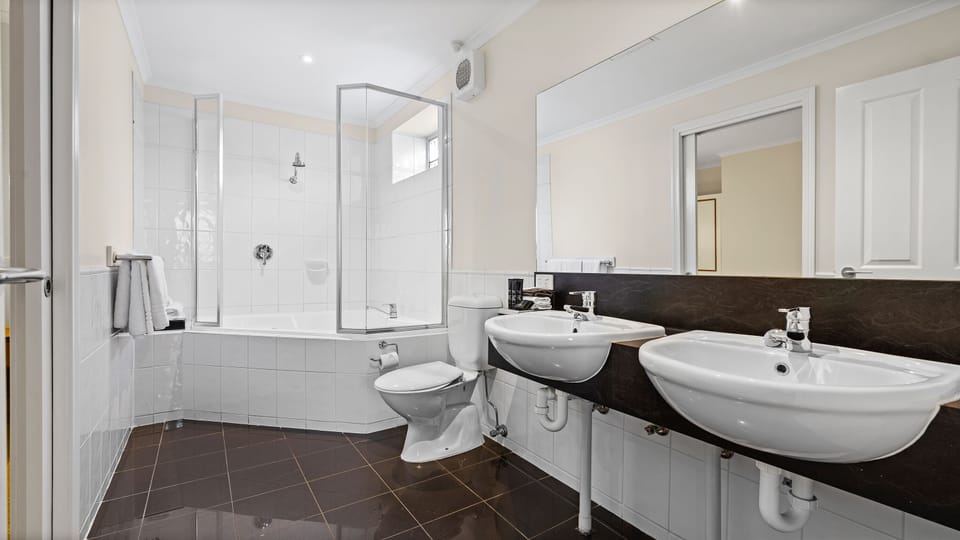 Shower, designer toiletries, hair dryer, towels