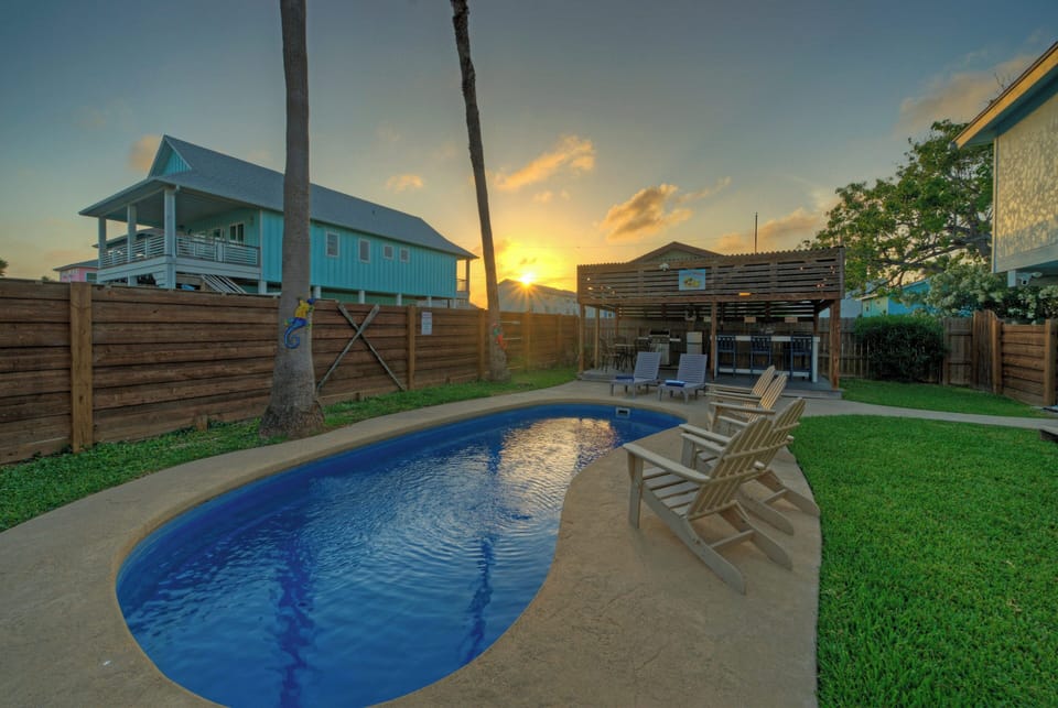 Private pool with sunset views and outdoor lounge.