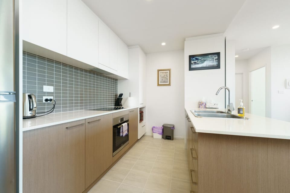 Open kitchen with bench space and views of Canberra’s skyline.