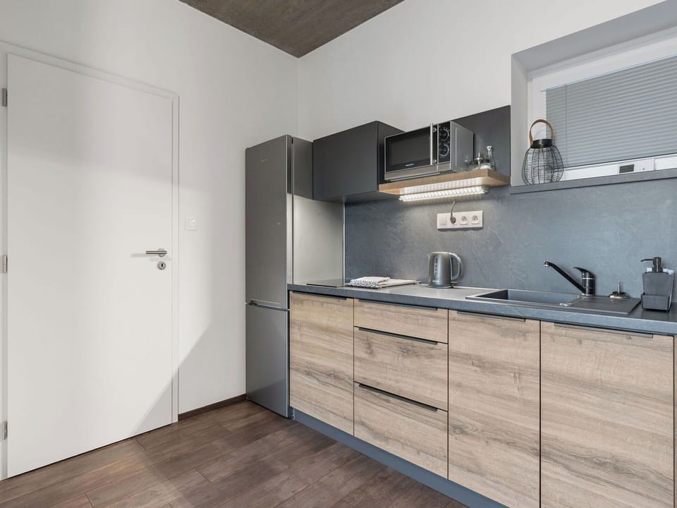 Wood, Flooring, Interior Design, Floor, Cabinetry, Apartment, Room, Furniture, Countertop, Kitchen