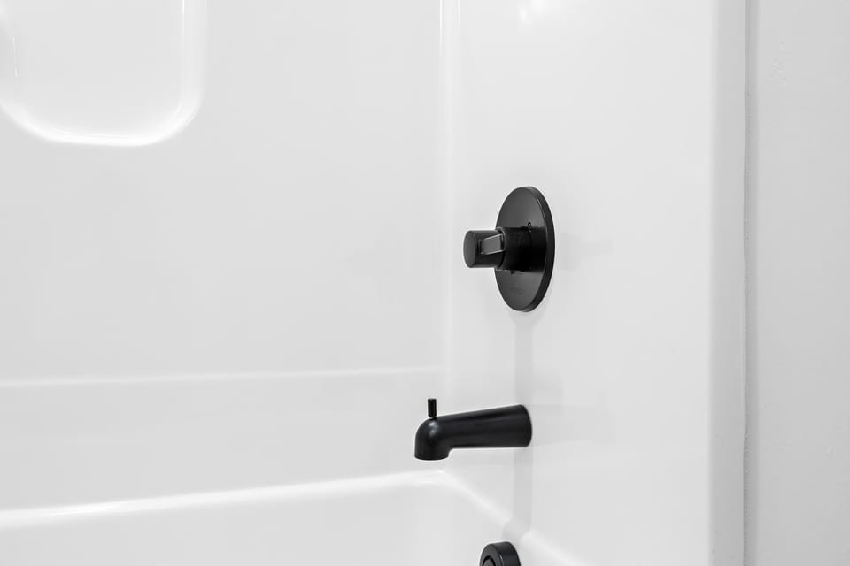 Bathroom: Simple and elegant—your shower features modern black fixtures for a sleek finish.