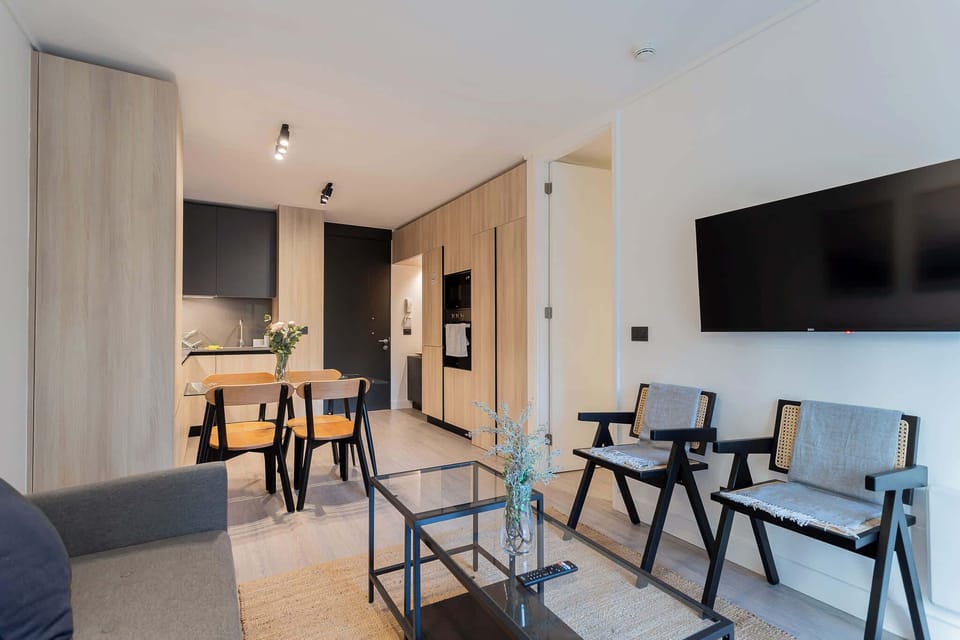 Experience modern comfort in this stylish living space, featuring a cozy dining area and sleek kitchen, perfect for your getaway.
