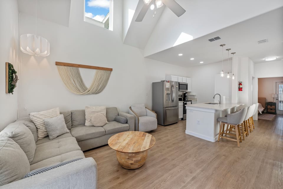 Relax in this bright open-plan space where soaring ceilings and natural light create your perfect retreat for unwinding.