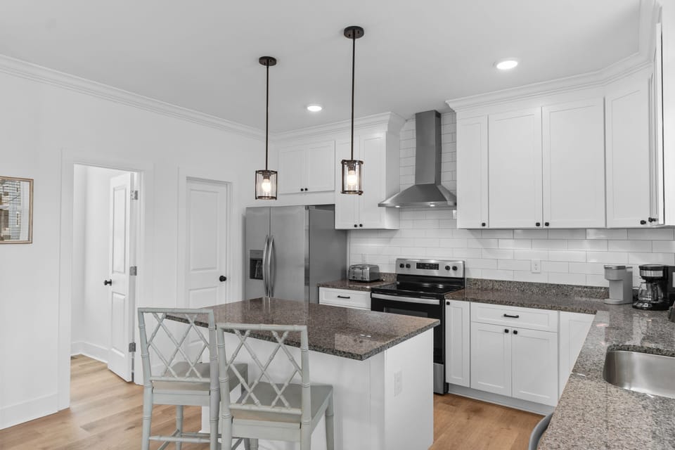 Your spacious kitchen features granite countertops, stainless steel appliances, and a breakfast bar where you can enjoy morning coffee.