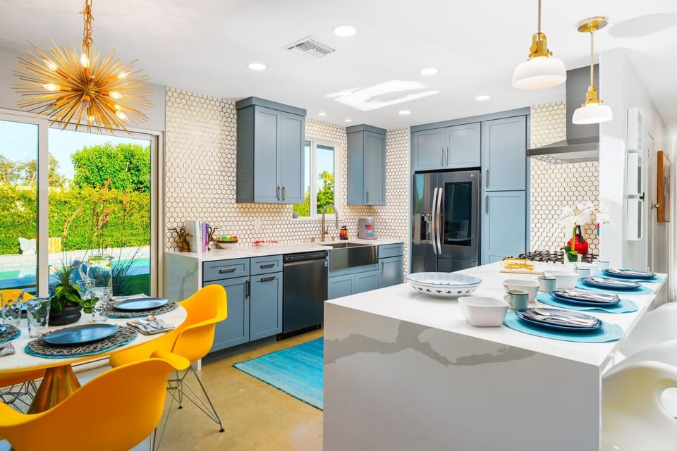 The kitchen features 4 bar-stool seating/dining table for 4, stainless steel appliances, and cooking essentials				

