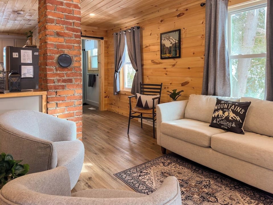 Lounge in style on our plush gray sofa set, surrounded by warm cabin vibes. 
