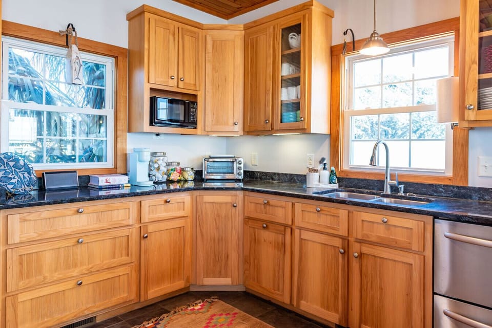Modern kitchen with stainless steel appliances and generous prep space—great for home-cooked meals during your stay
