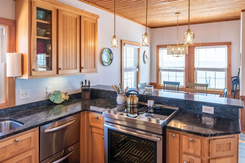 Modern kitchen with stainless steel appliances and generous prep space—great for home-cooked meals during your stay