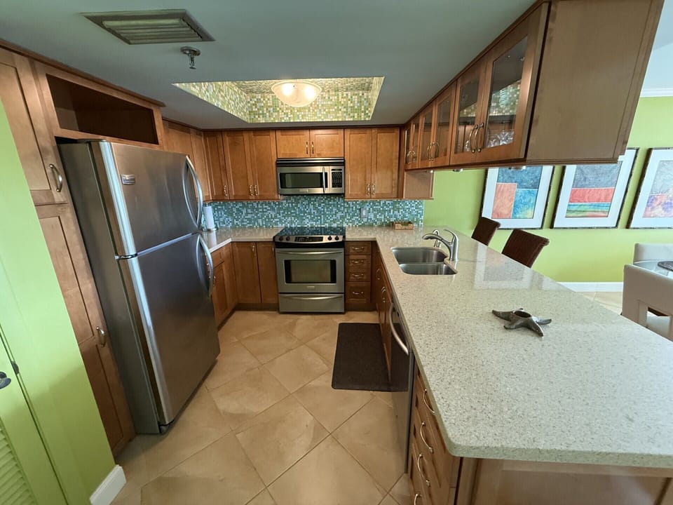 Kitchen is well stocked with dishes and pots and pans for cooking 