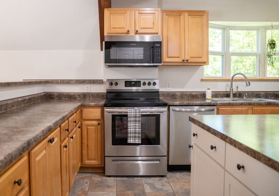 Full kitchen with stainless steel appliances 