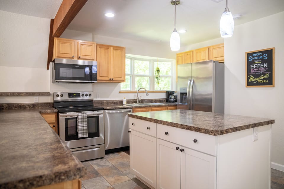 Full kitchen with stainless steel appliances 