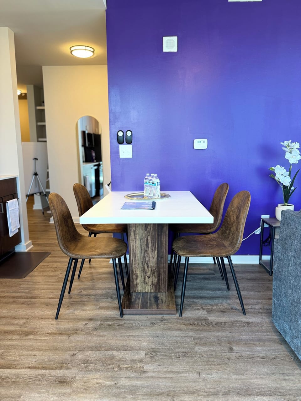 Gather around the modern dining table, perfectly positioned within the open-concept layout for meals, game nights, or relaxing conversations during your stay.