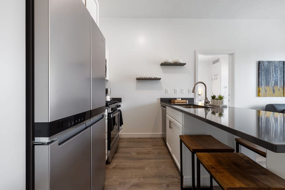 view of the kitchen with an eat-in nook and fridge and sink and stove
