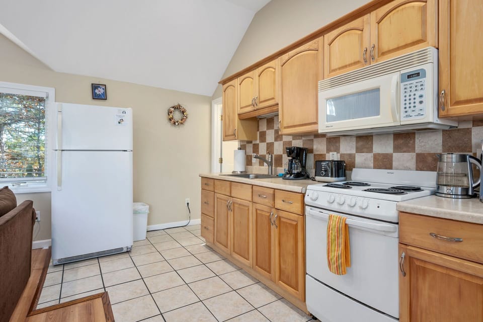Kitchen with full size fridge, stove/oven and microwave
