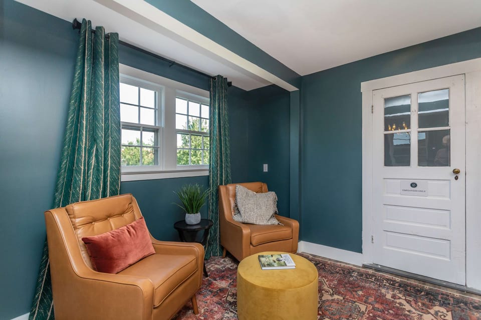 Cozy seating area with leather chairs and natural light from the window