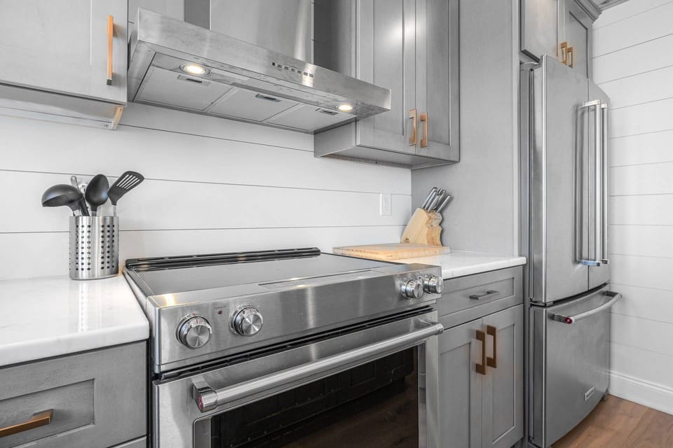 Kitchen with stove and plenty of cooking essentials