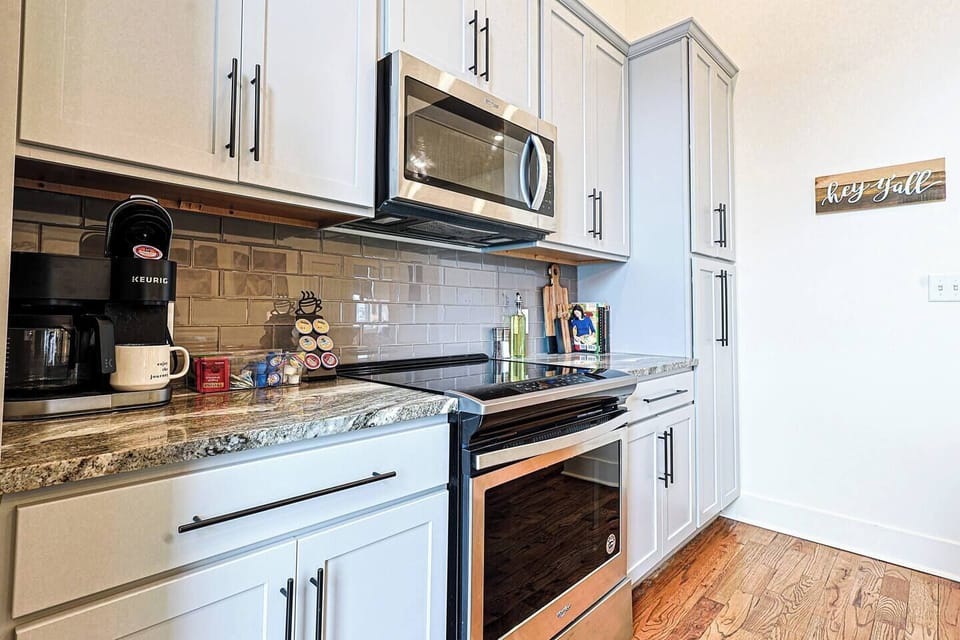 Kitchen: Modern appliances and stylish decor make cooking a delight in this charming space!
