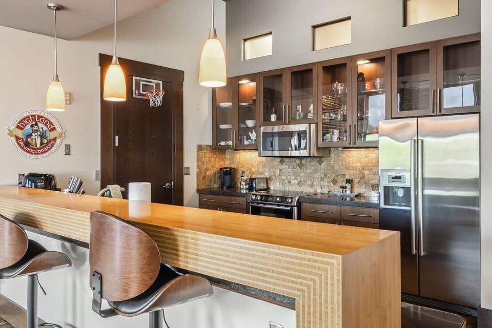 Kitchen: Modern elegance meets functionality with sleek appliances and inviting bar seating!