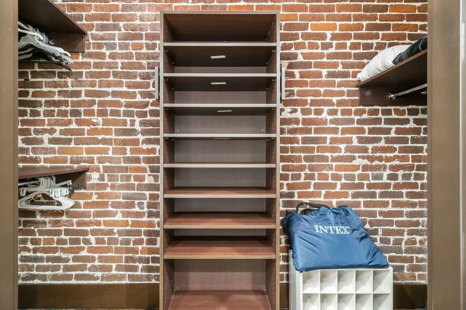 Storage Oasis: Ample shelving and stylish brick walls make organizing a breeze!