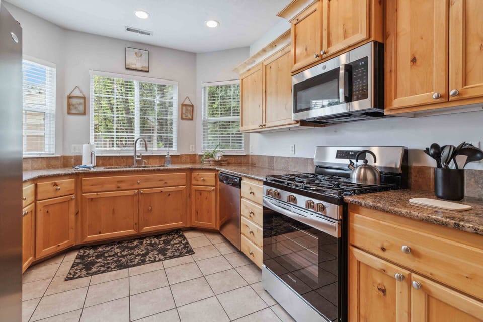 Cook up a feast in the fully-equipped kitchen with granite counters and shiny stainless steel appliances including gas range