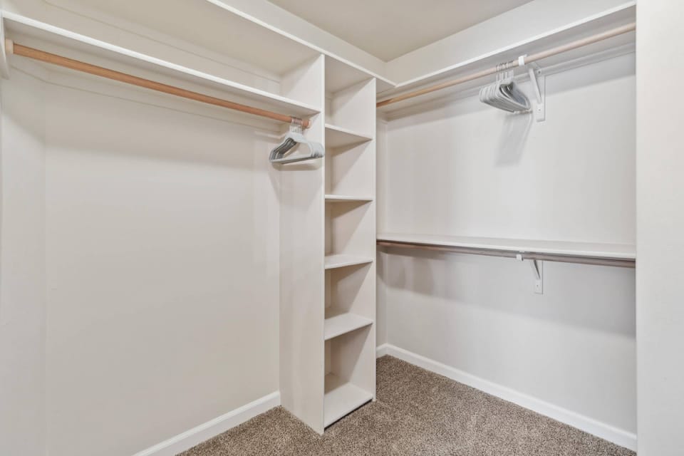 Walk-in closet in the luxurious primary en suite