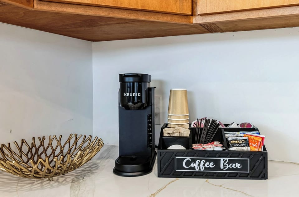 Complimentary Keurig & tea station with cups or mugs ready for morning brews.