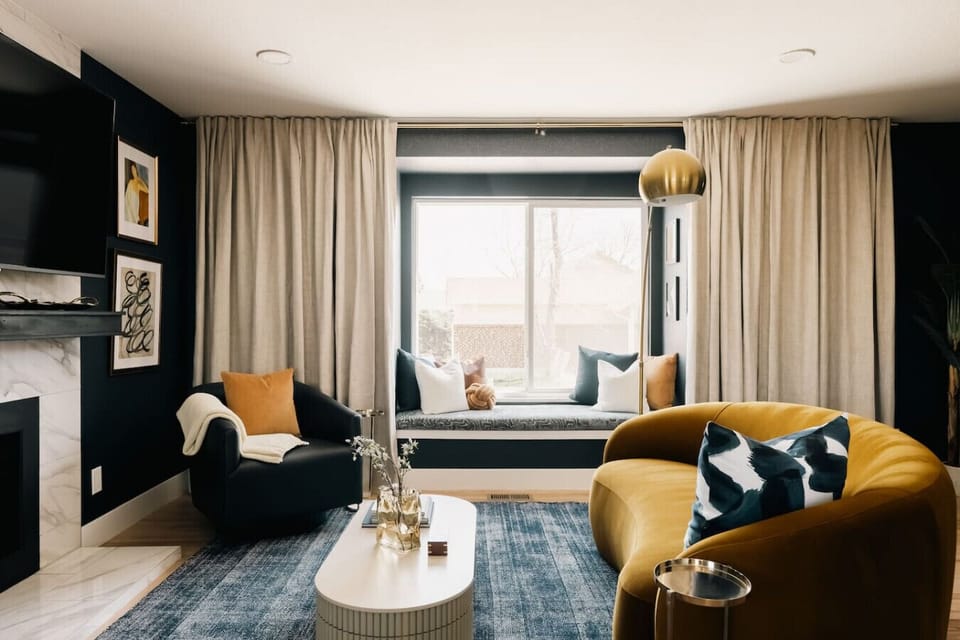 Spacious and elegant living room with comfortable seating, a gas fireplace, and large smart TV