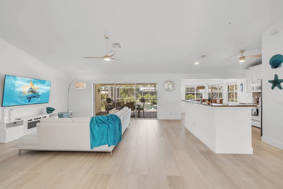 - Enjoy an airy layout with light wood flooring and open flow from living room to kitchen
- Sliding doors open to the pool while stylish décor completes the beachy vibe
- Ideal for entertaining, lounging, or quiet family time