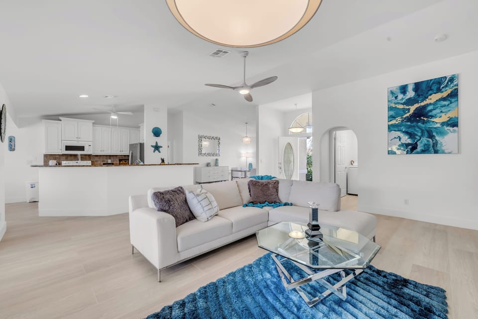 - Airy living space features crisp white tones, bold artwork, and open sightlines
- Contemporary touches meet laid back coastal style for stylish relaxation
- Perfect for movie nights or lounging after a beach day