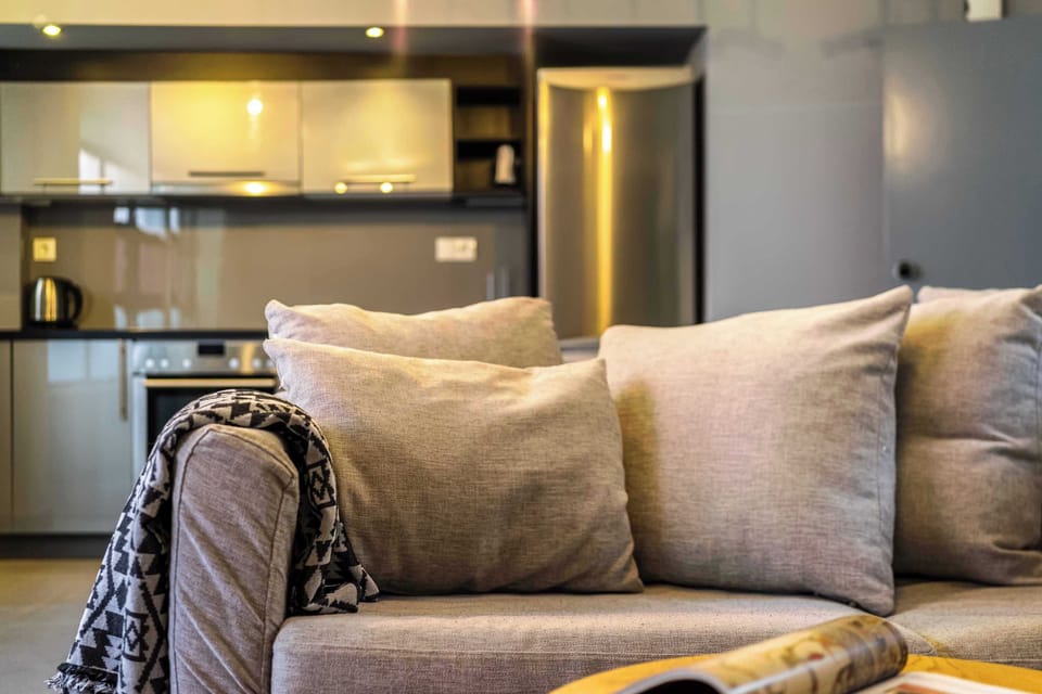 Comfortable sofa detail highlighting soft textures and relaxed atmosphere throughout the stylish apartment.