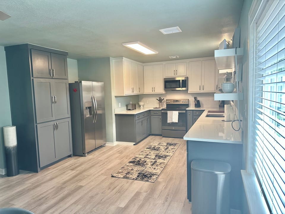 Open kitchen with all new appliances and fully stocked with housewares 