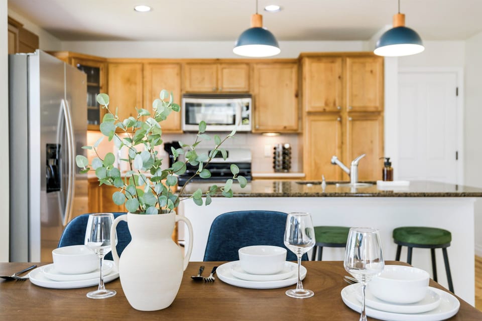 Gather around the inviting dining table, perfect for meals and conversation. Seating for six makes it ideal for family dinners, with warm lighting and a welcoming vibe that encourages lingering. All place settings are included.