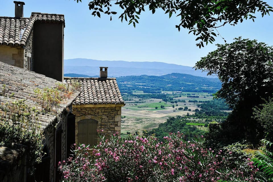 Explore the stunning hills, where vibrant blooms contrast with rustic rooftops.