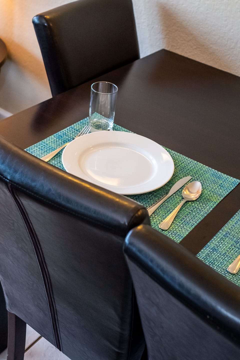 This dining area offers a stylish setting with a fully equipped kitchen nearby, ready for meals and entertaining.