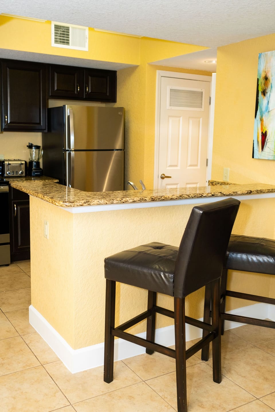 Discover a stylish kitchen featuring sleek granite countertops and modern appliances, perfect for culinary adventures.
