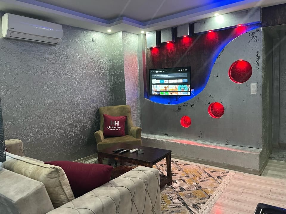 Deluxe Suite | Living area | 55-inch Smart TV with digital channels, first-run movies, printers