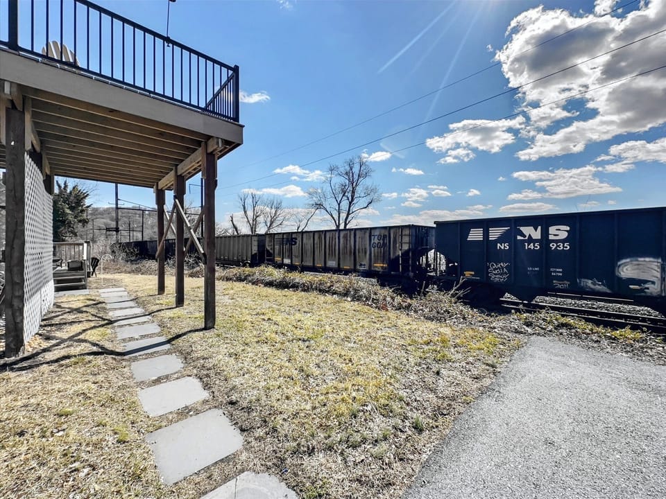 Walk along the private path beside the deck, steps from riverside serenity and outdoor adventure.