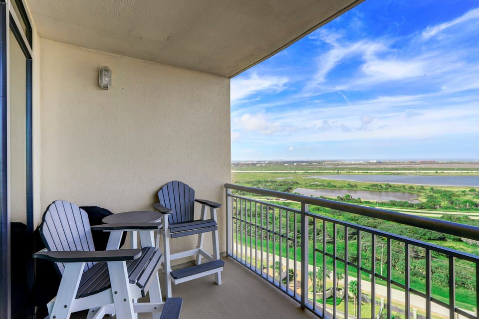 Private balcony with high-top seating and panoramic views of Galveston Bay—perfect for morning coffee or evening sunsets.